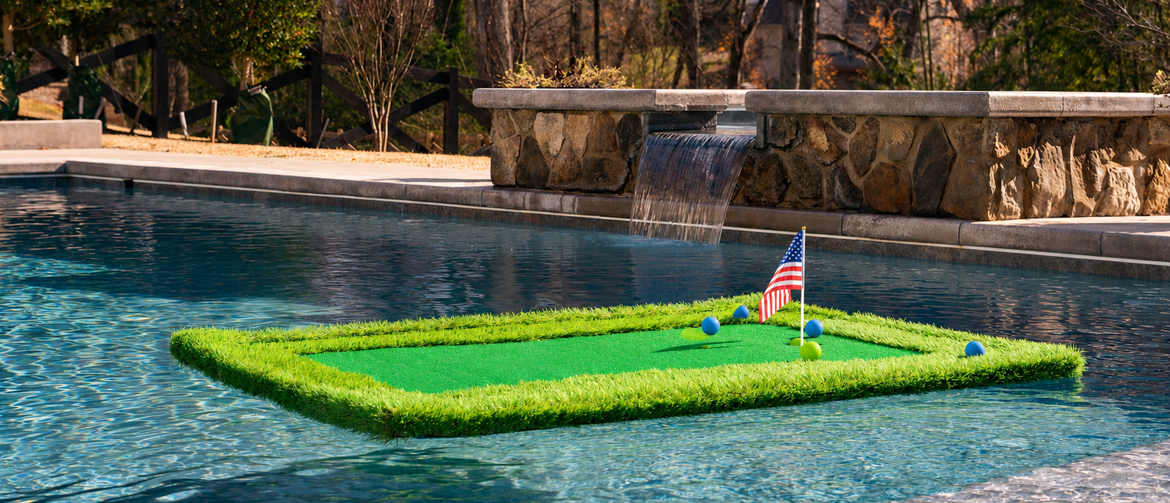 Float N Chip Floating Golf Green set up in a pool with grass and flags, surrounded by trees and a stone wall.
